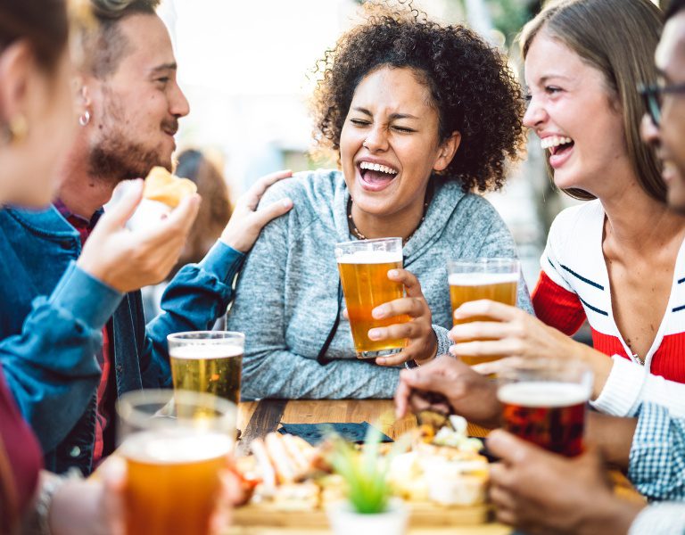 group of friends gather around a table drinking beer in sonoma county