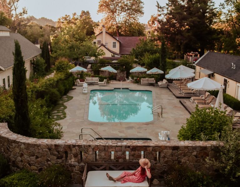 overlooking pool surrounded by brick walls at farmhouse inn