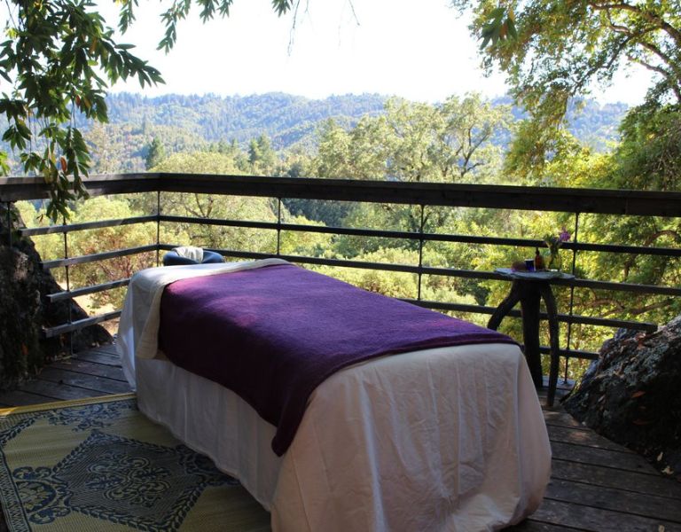 massage table sits atop a balcony overlooking vineyards in sonoma