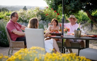 Photo of family relaxing outside Sonoma County vacation rentals with Woodfield Properties