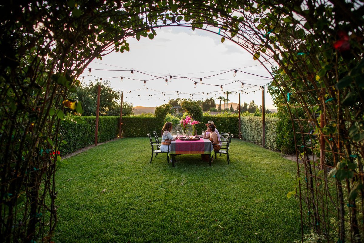group of people sitting at garden table
